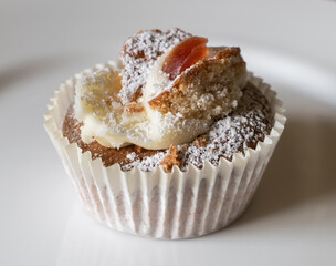 Small cupcake with cream and fruit
