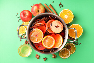 Concept of cooking  mulled wine on green background