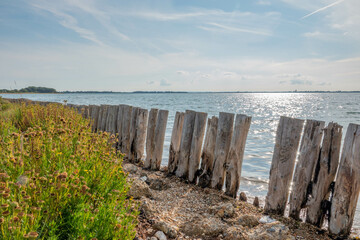 beautiful rustic deserted English beach in West Sussex England on a bright Autumn day	
