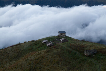 The trail to Koruldi lakes from Mestia. Big Caucasus. First snow. Abandoned small house on the hill...