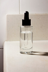 glass containers with cosmetic acid pipette on bathroom cabinet top skin serum pipette containers on bathroom vanity unit