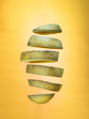 Chopped floating potato on orange background