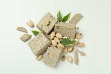 Halva with pistachio and leaves on white background