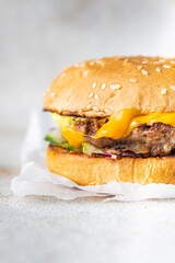 cheeseburger burger homemade bun, cheese, vegetable, grilled cutlet minced meat pork, beef fast food meal snack copy space food background rustic 