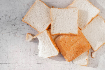 Bread slides on white wooden background