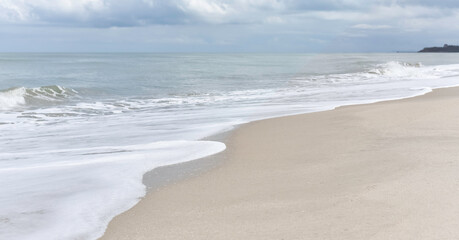 Fototapeta na wymiar White soft Seawave surf on the beach,