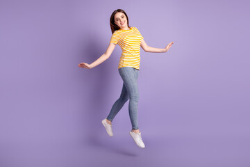 Fototapeta na wymiar Full size profile side photo of young pretty girl good mood jump go walk isolated over purple color background