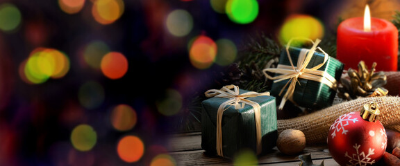 traditional christmas decoration on a wooden table and colorful blur lights
