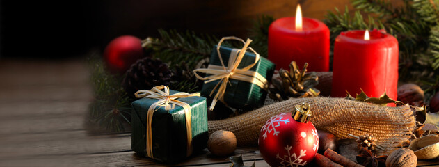 traditional christmas decoration on a wooden table with gifts, canddles