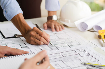Close-up of an engineer planning a hand-drawn design. with architect equipment Architects talking...