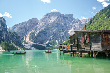 Lake Braies (also known as Pragser Wildsee or Lago di Braies) in Dolomites Mountains, Sudtirol, Italy. Romantic place with typical wooden boats on the alpine lake. Hiking travel and adventure.