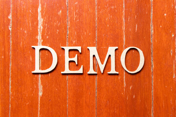 Alphabet letter in word demo on old red color wood plate background