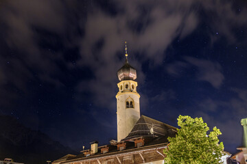 Fototapeta na wymiar Night view of Collegiata di San Candido, Stiftskirche Innichen, San Candido, Innichen, Val Pusteria, Bolzano, Trentino Alto Adige, Italia