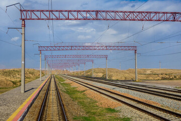 Railroad station in the middle of deserted hills with small islands of vegetation. Shot in eastern Uzbekistan