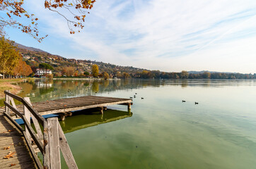 Autumn landscape of Lake Varese with Lakeside promenade in Gavirate, province of Varese, Italy.