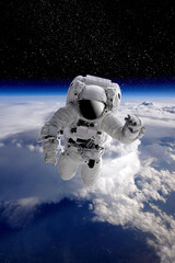 Astronaut in outer open space over the planet Earth.Stars provide the background.erforming a space...