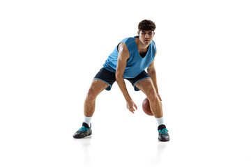 Full length portrait of basketball player practicing isolated on white studio background. Tall...
