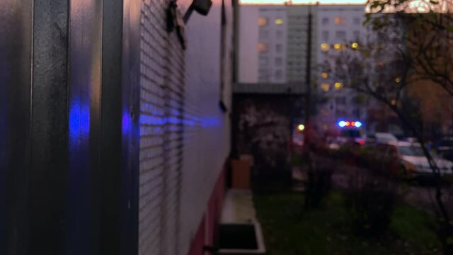 Blurry image of blue ambulance flashing siren lights at night