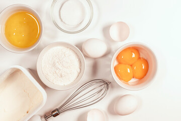 Baking utensils and cooking ingredients for tarts, cookies, dough and pastry. Flat lay with eggs, flour, sugar, cottage cheese