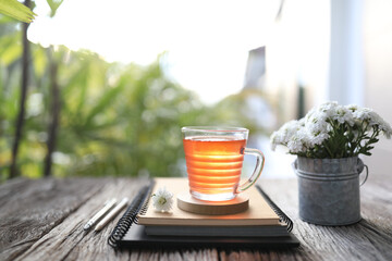 strawberry juice and notebooks and pencil and pot of chrysanthemum flowers