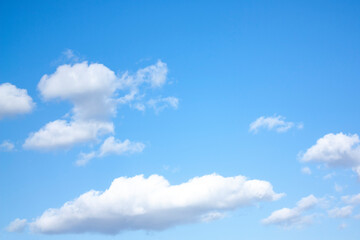 Naklejka na ściany i meble High, fluffy clouds against the blue sky. Beautiful view of the blue sky. Heavenly background. 