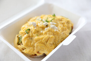 Avocado and scrambled eggs toast with delivery package in white background