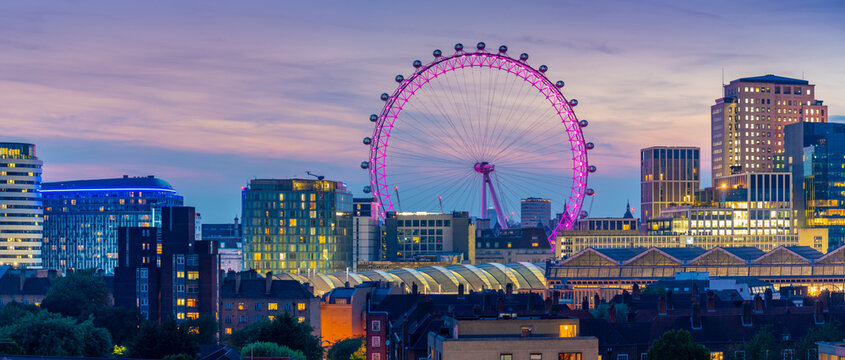 View of the London Eye and rooftop of Waterloo Station at dusk, Waterloo, London