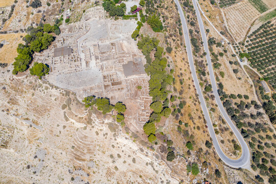 Aerial view of hairpin bends of road near the old ruins of Phaistos Palace and archaeological site, Crete, Greek Islands