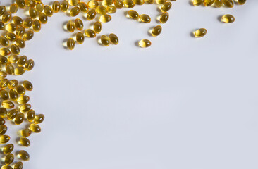 White frame background from tablets of gelatinous golden yellow capsules, vitamin D3. Beautiful colored golden vitamin D3. A bunch of vitamin D3.