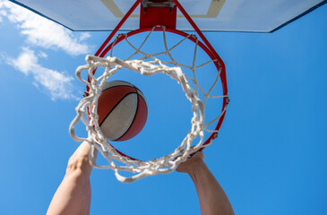 basketball ball flying through basket in players hands, winning © Olena