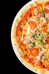 Delicious pizza close up, white plate on black background