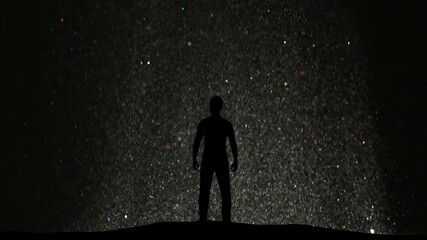 The man standing on a flying shimmering particles background