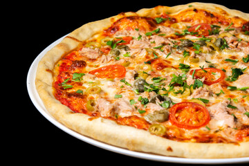 Delicious pizza close up, white plate on black background