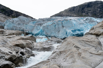 Naklejka premium Vibrant blue glacier in Norway, showcasing the icy beauty of the landscape. 