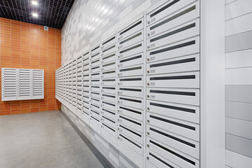 A lot of new mailboxes in an apartment building. New building, mailboxes in the lobby of an apartment building