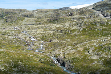 Vast mountainous landscape with lush green valleys in Norway, perfect for exploration.