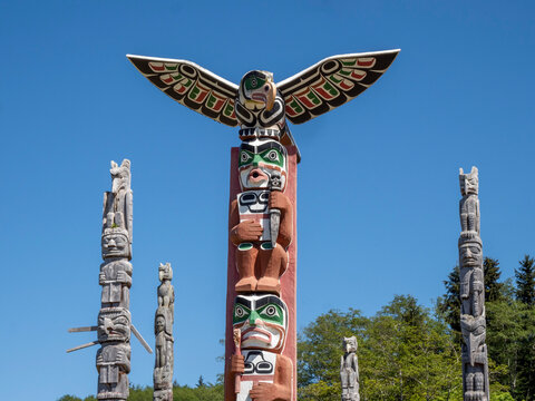 Kwakwaka'wakw totem poles in the cemetery in Alert Bay, Cormorant Island, British Columbia, Canada