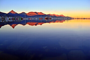 sunset in the city of ushuaia, the waters of the calm beagle channel