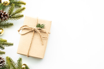 Fototapeta na wymiar Beautiful Christmas background with gift box, decorate with pine branch and pine cone over white background. Top view with copy space, flay lay.