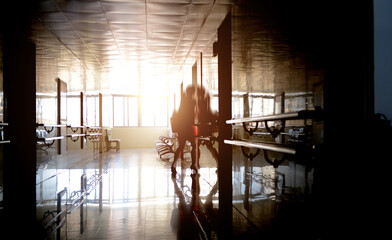 People walking through the hospital corridor