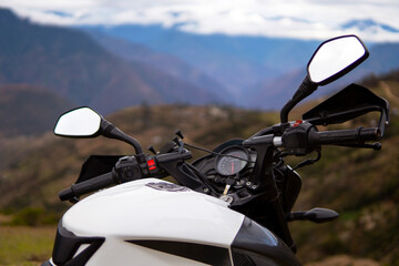 a motorcycle on top of a mountain watching the horizon
