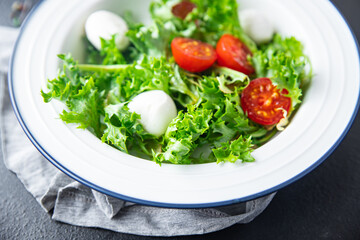 mozzarella salad tomato lettuce vegetable vitamins meal snack on the table copy space food background rustic. top view keto or paleo diet veggie vegan or vegetarian food