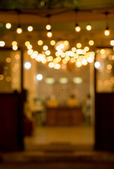 vintage tone blur image of food stall at night festival with bokeh