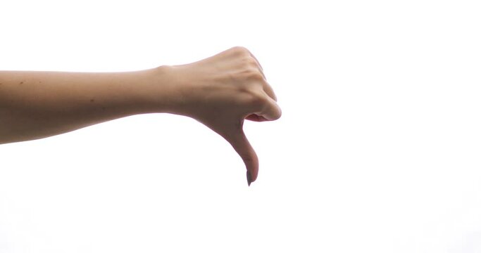 Isolated female hand showing thumbs down on white background. No-like, Dislike or Negative Sign Symbol. Gestures.