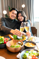 asian marry couple happiness cheerful dinner ,Beautiful adult couple toasting with glasses of wine sitting at wooden table.thanksgiving dinner christmas festive holiday,family celebrate concept