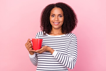 Photo of charming positive lady arms hold showing cup toothy smile isolated on pink color background