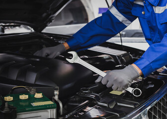 The mechanic works in the garage for repair service.