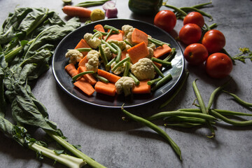 Close up of fresh raw vegetables on a plate. Selective focus.