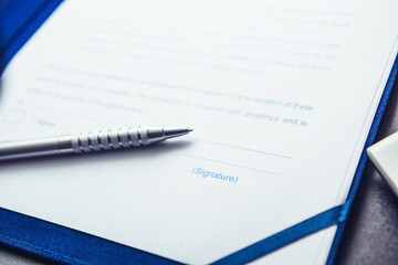 Pages of sales agreement and silver pen. A contract ready to be signed.