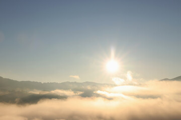 Aerial view of beautiful mountain landscape with thick mist at sunrise